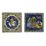 TWO QAJAR POLYCHROME-PAINTED MOULDED POTTERY TILES