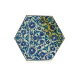 A BLUE AND WHITE HEXAGONAL IZNIK POTTERY TILE