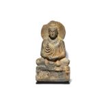 A CARVED GREY SCHIST FIGURE OF A SEATED BUDDHA