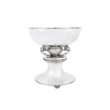 A large George V ‘arts and crafts’ sterling silver bowl on stand, London 1935 by Charles Boyton