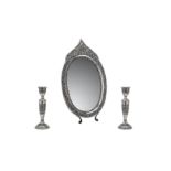 A late 20th century Iranian unmarked silver dressing table mirror and candlesticks, probably