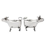 A matched pair of late 19th century / early 20th century German 800 standard silver cow creamers,