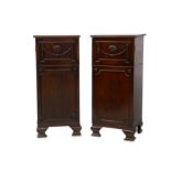 † A pair of Neoclassical mahogany pedestal cabinets