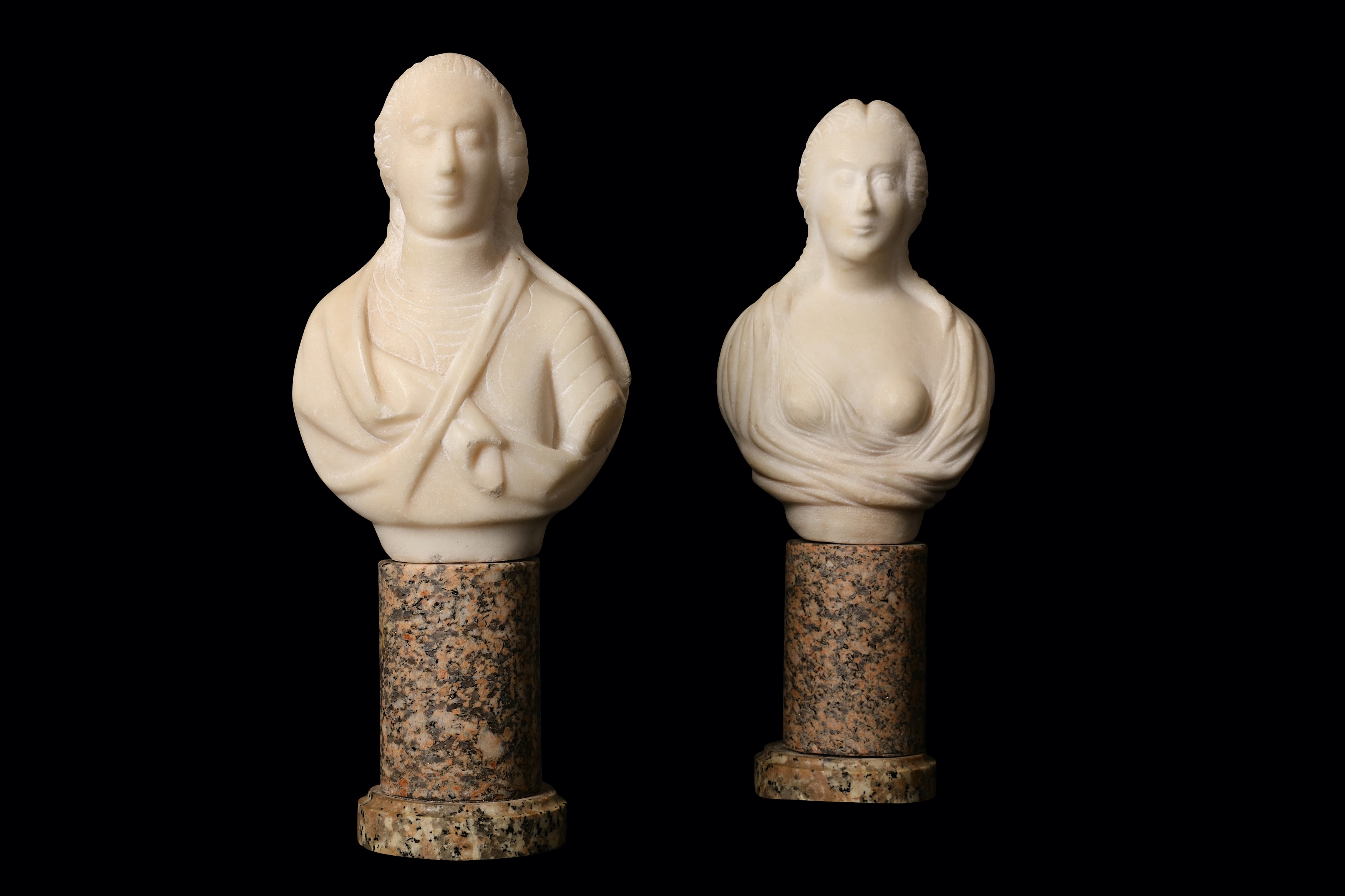 A pair of small white marble busts of a lady and gentleman