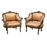 A pair of 19th Century French walnut Rococo style fauteuil tub chairs