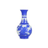 A Chnese Pekng glass blue overlay 'peony' bottle vase.