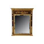 An Italian reproduction Empire style parcel gilt and hardwood overmantel mirror