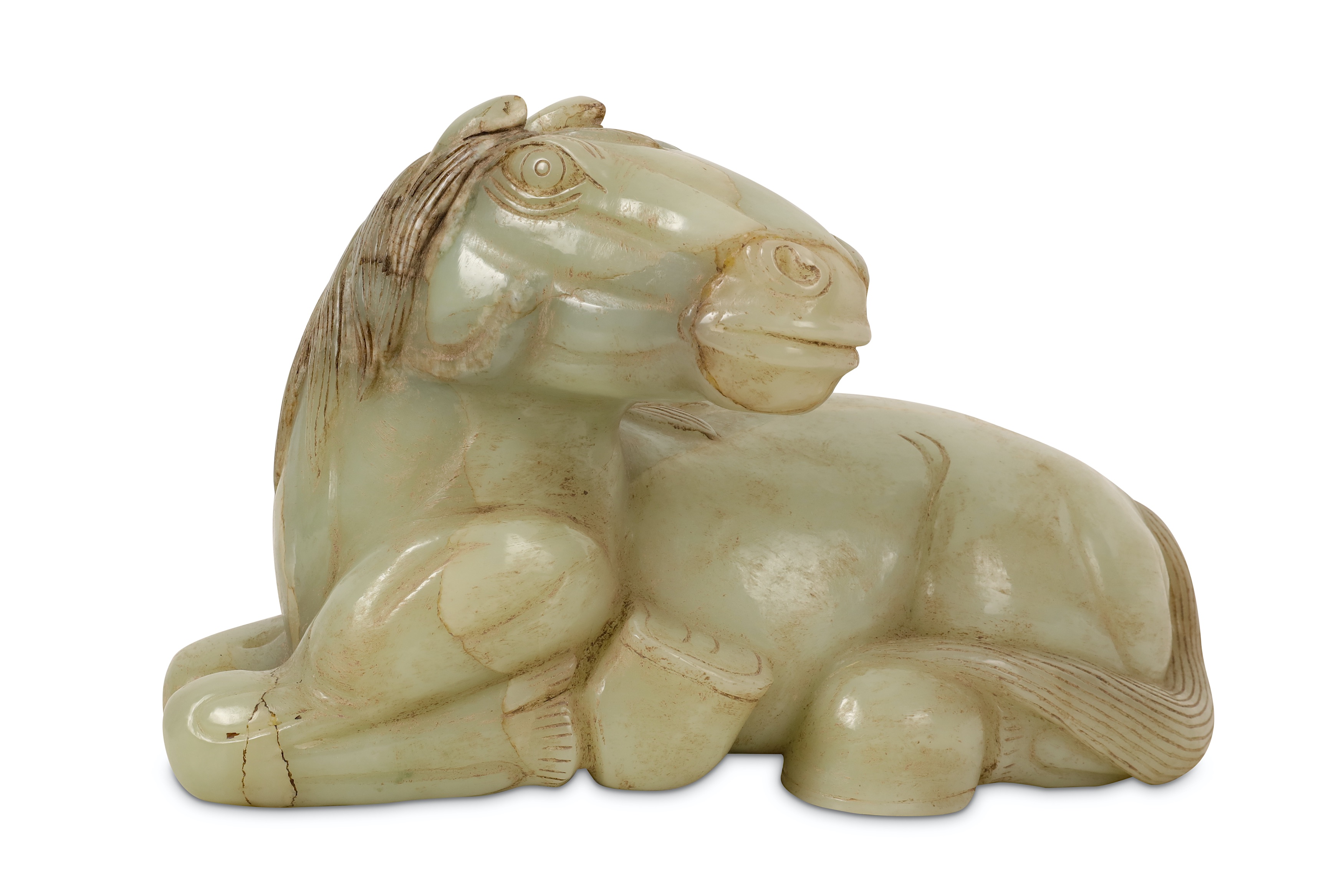 A CHINESE PALE CELADON JADE CARVING OF A RECUMBENT HORSE.