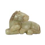 A CHINESE PALE CELADON JADE CARVING OF A RECUMBENT HORSE.