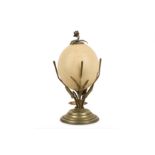 AN EARLY 20TH CENTURY SILVERED BRASS MOUNTED OSTRICH EGG