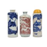 TWO CHINESE BLUE AND WHITE AND ONE UNDERGLAZE RED 'DRAGON' SNUFF BOTTLES.