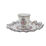 A CHINESE CANTON ENAMEL FAMILLE ROSE 'CHERRY PICKERS' CHOCOLATE CUP AND TREMBLEUSE STAND.