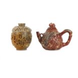 A CHINESE SOAPSTONE 'MAGNOLIA' TEAPOT AND COVER AND A SOAPSTONE 'GRAPEVINE' CUP AND COVER.