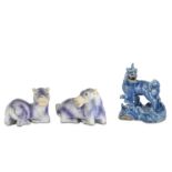 A CHINESE BLUE-GLAZED BISCUIT MODEL OF A QILIN AND A PAIR OF PURPLE-GLAZED ANIMALS.