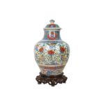 A CHINESE BLUE AND WHITE ENAMELLED VASE AND COVER.