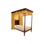 An early 20th Century Heal & Son walnut four poster bed