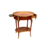 An early 20th Century French walnut etagere of oval form