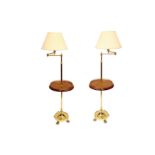 A pair of brass lamps and a mahogany table