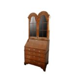An Edwardian Queen Anne style walnut bureau bookcase