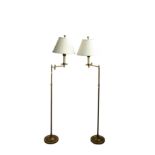 A pair of adjustable brass reading standard lamps