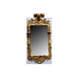 WITHDRAWN - A George III gilt framed wall mirror, surmounted by a carved ho ho bird.