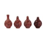 A collection of Chinese cinnabar lacquer snuff bottles together with a miniature vase.