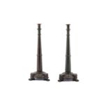 A pair of Gothic style cast bronze candlesticks