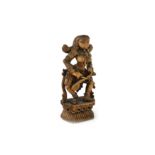 A carved wooden South Indian statuette of a female musician