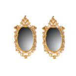 A pair of 19th Century giltwood oval mirrors