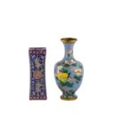 A Chinese blue ground famille rose porcelain pillow together with a cloisonne enamel vase.