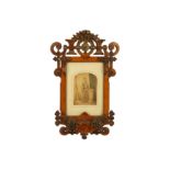 A Victorian hand tinted photograph housed in a oak Gothic Revival frame