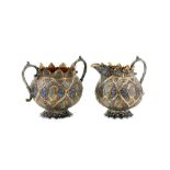 An early 20th century Anglo – Indian Raj unmarked silver parcel gilt and enamel milk jug and twin