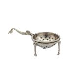 A George V Scottish sterling silver Traprain Hoard tea strainer on stand, Edinburgh 1925 by Brook