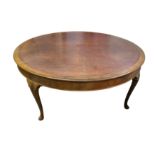 A circa 1930's large circular walnut and tooled brown leather library table