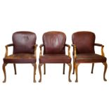 A set of seven circa 1930's George I style walnut library open armchairs