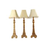 Three 20th century gilt columnar table lamps