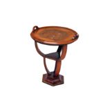 An Art Deco walnut etagere of circular form