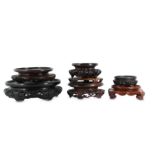 § SEVEN CHINESE CIRCULAR WOOD STANDS.