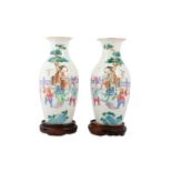 A PAIR OF CHINESE FAMILLE ROSE 'LADY AND BOYS' VASES.