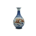 A CHINESE BLUE AND WHITE AND OVERGLAZE RED 'DRAGON' BOTTLE VASE.