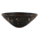 A CHINESE SLIP-DECORATED CONICAL BOWL.