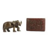A CHINESE CINNABAR LACQUER BOX AND COVER AND A SOAPSTONE BUFFALO CARVING.