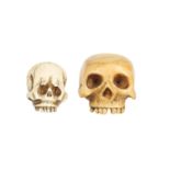 λ TWO IVORY SKULL NETSUKE.