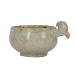 A SMALL KOREAN CELADON HANDLED BOWL.