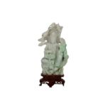 A CHINESE JADEITE CARVING OF A SEATED GUANYIN.