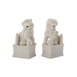 A PAIR OF CHINESE BLANC-DE-CHINE LION DOG JOSS STICK HOLDERS.