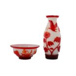 A RED OVERGLAZED CHINESE PEKING GLASS VASE AND BOWL.