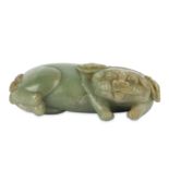 A CHINESE PALE CELADON JADE CARVING OF A LION DOG.