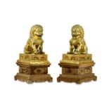 A PAIR OF LARGE CHINESE GILT-METAL LIONS AND STANDS.