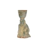 A CHINESE GREEN-GLAZED POTTERY CANDLESTICK.